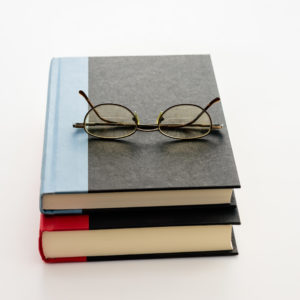 Glasses on top of two hardcover books