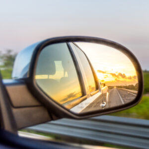 Sunset Through Truck Rear View Mirror on the Highway