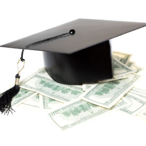 Paid education. Graduate cap on a pile of money