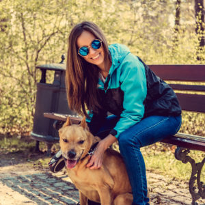 Casual brunette female with her brown dog.