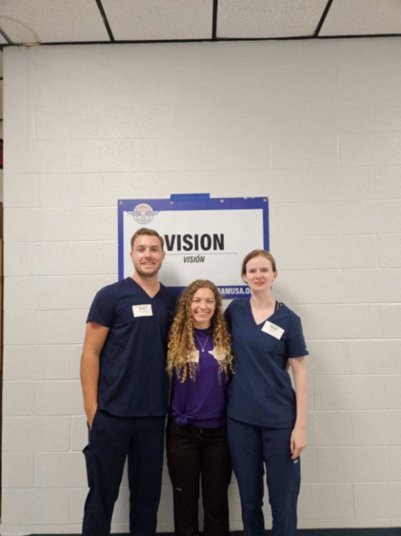 Students under 'Vision' signage during vision clinic